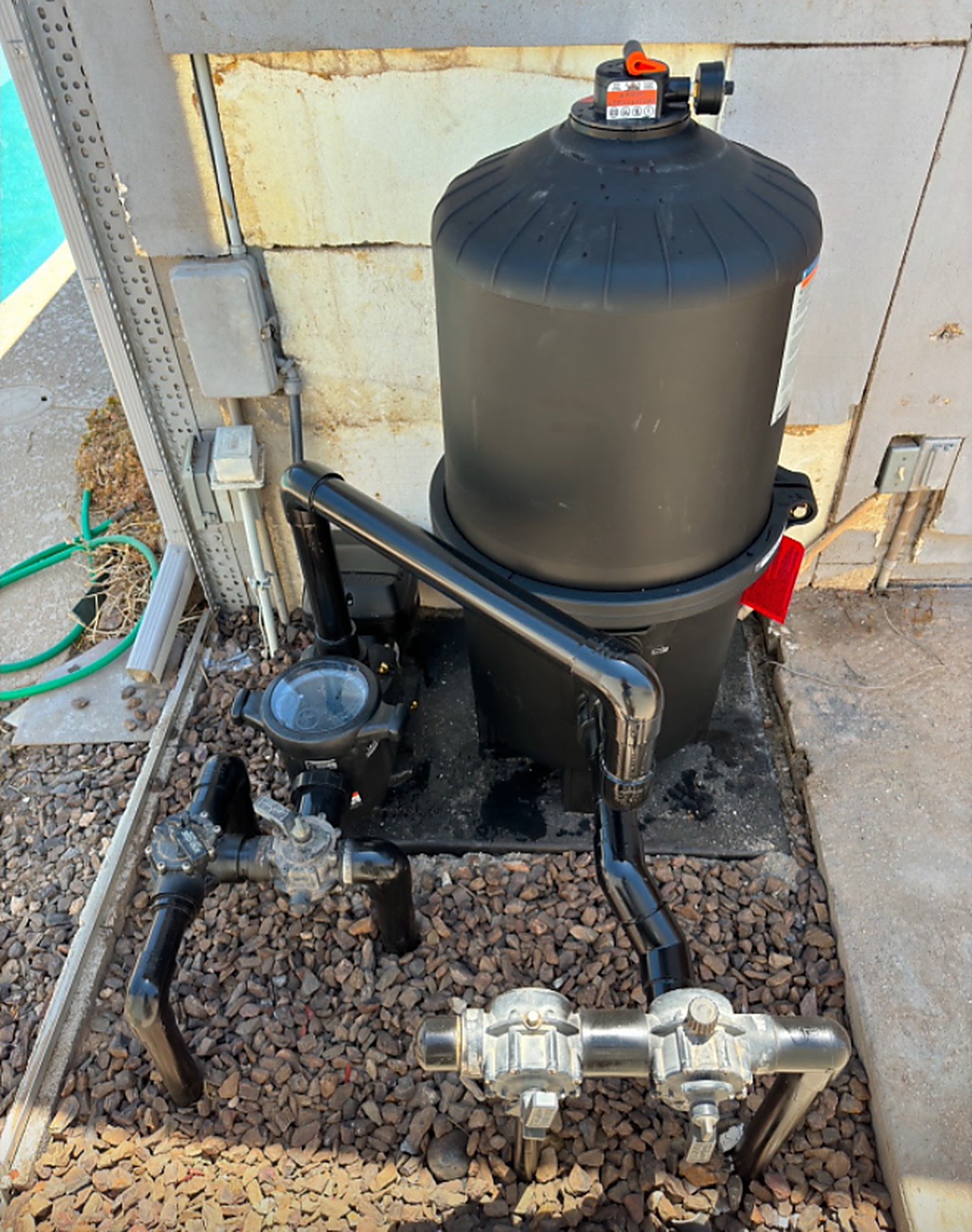 After: a new black cartridge filter system installed with clean plumbing
