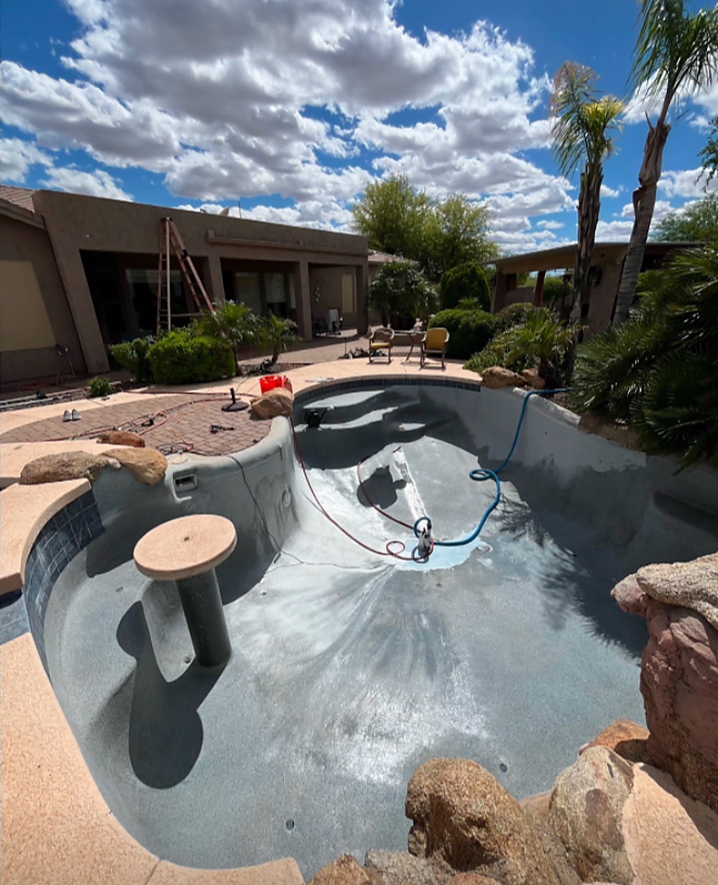 After: the finished pool with new surface, being filled